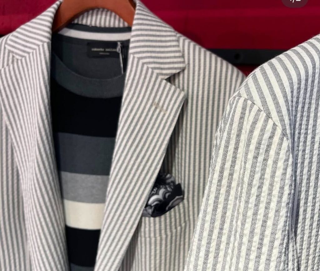 都会的なイタリアスタイル。グレーのストライプジャケットにモノトーンボーダーのニットをインナーに合わせた、5月後半の大人の夏日コーディネート。