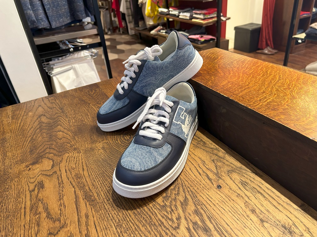 etroのネイビースニーカーのペアが木製テーブルに置かれた様子。白いペガサスのロゴデザイン。