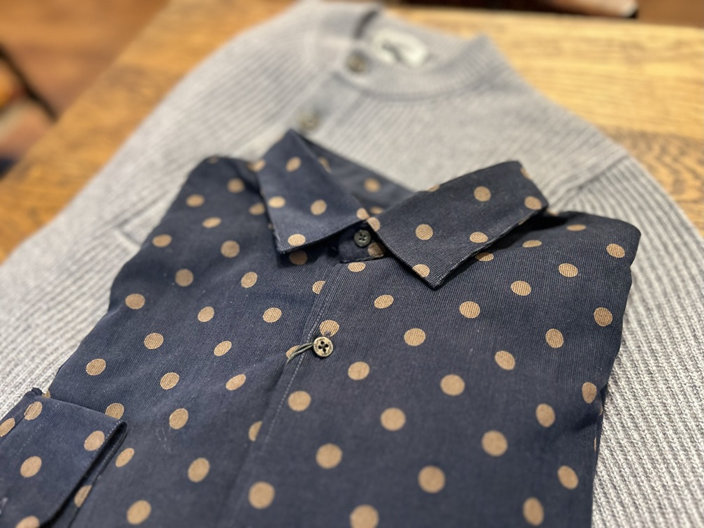 グレーのニットの上に重ねたcostumeinのコーデュロイドットシャツのスタイリング