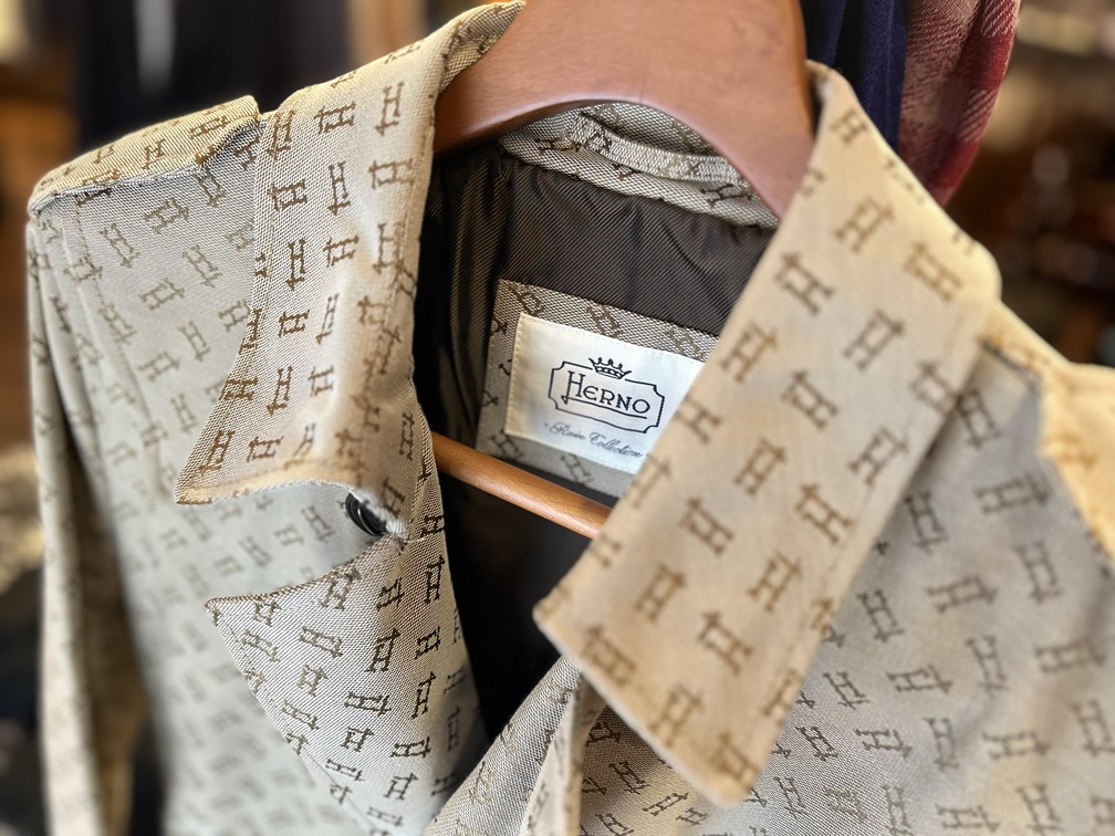 HERNOロゴを全面にあしらった総柄コート。クラシックで洗練されたモノグラムデザインが特徴。